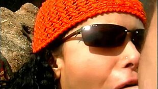 a mature man fucks an exotic babe in a cap and sunglasses on the seaside stones