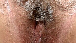 hairy pussy close up as brunette in stockings masturbates with bottle fetish