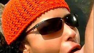 a mature man fucks an exotic babe in a cap and sunglasses on the seaside stones