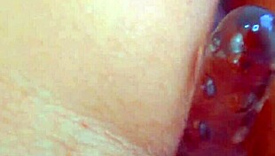 Desi beauty uses glass dildo for close-up masturbation, reaching orgasm with her shaved pussy.