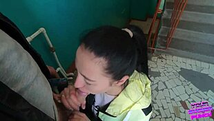 Risky blowjob on public staircase. Brunette teen sucks huge cock outdoors.