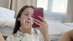 Ellie Leen fingers her hairless shaved pussy in front of the mirror