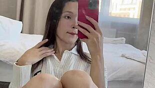 Ellie Leen fingers her hairless shaved pussy in front of the mirror
