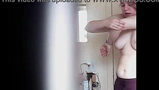 Blonde woman with big boobs is changing her clothes