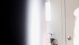 Blonde woman with big boobs is changing her clothes