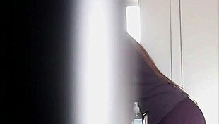 Blonde woman with big boobs is changing her clothes