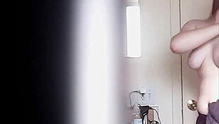 Blonde woman with big boobs is changing her clothes