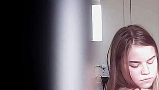 Blonde woman with big boobs is changing her clothes