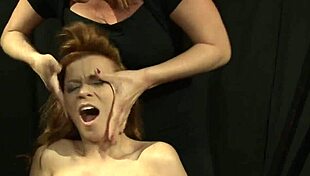 redhead lezdom punishes bound sub with dildo