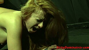 redhead lezdom punishes bound sub with dildo