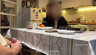 In the kitchen, my husband jerks under the table in front of my step mom and me