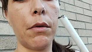 kelly kendricks smokes in the sun, showing lots of cleavage 😎