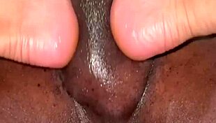 Amateur gives footjob massage to big black cock.