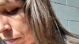 kelly kendricks smokes in the sun, showing lots of cleavage 😎