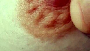 A braless woman reveals her nipple