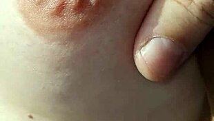 A braless woman reveals her nipple