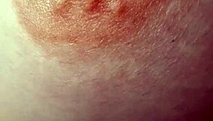 A braless woman reveals her nipple