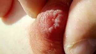 A braless woman reveals her nipple