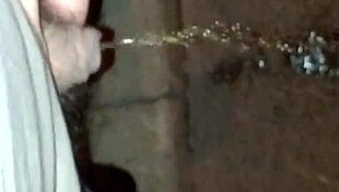 guy sneaks a pee on the empty street corner