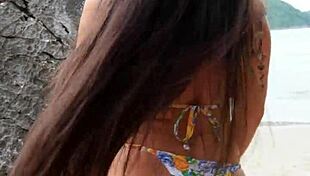 pretty tanned girl flashes bikini legs while dancing on hidden beach spot