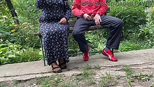 Mature woman handles huge shaft outdoors into glass