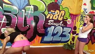 Sporty blonde lesbian licks brunette's shaved pussy with dildo