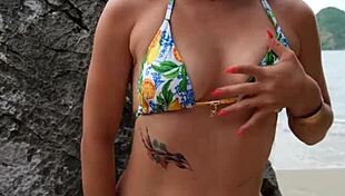 pretty tanned girl flashes bikini legs while dancing on hidden beach spot