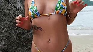 pretty tanned girl flashes bikini legs while dancing on hidden beach spot