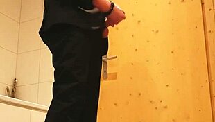 guy strokes his cock hard in tight business suit on bed