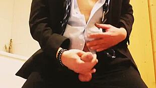 guy strokes his cock hard in tight business suit on bed