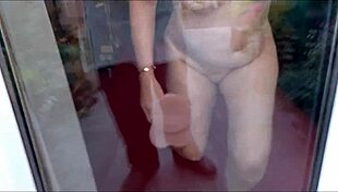 Desperate Housewife Fucks Dildo Against Window to Orgasm