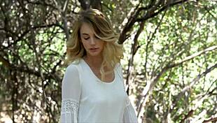 stunning blonde feels wild thrill stripping naked amid forest trees