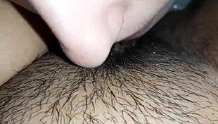 The brunette lesbian dives deep into her lover's hairy wet pussy up close