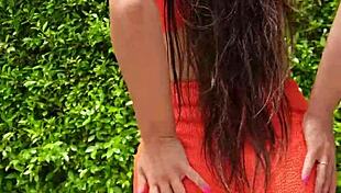 woman flashes orange bikini in sexy outdoor public tease