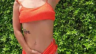 woman flashes orange bikini in sexy outdoor public tease