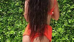 woman flashes orange bikini in sexy outdoor public tease