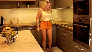 Long-Haired Blonde Coed in Miniskirt and Heels Flashes Ass and Pussy in Kitchen.