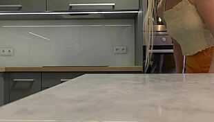 Long-Haired Blonde Coed in Miniskirt and Heels Flashes Ass and Pussy in Kitchen.