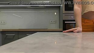 Long-Haired Blonde Coed in Miniskirt and Heels Flashes Ass and Pussy in Kitchen.