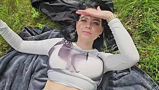 She smokes on the grass baring her huge natural tits in sunlight