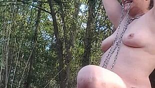 slave flashes natural tits during outdoor forest exhibition