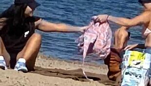 Juicy Asian teases beach cameltoe hidden!