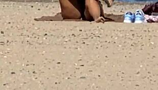 Juicy Asian teases beach cameltoe hidden!