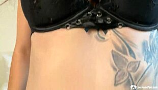 Amateur babe with big tits spreads wide on homemade camera showing tattooed body