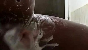 Horny guy strokes huge cock in steamy shower solo