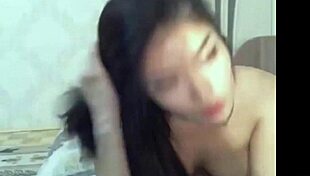 Horny Thai webcam amateur Asian stuffs dildo deep in shaved pussy masturbating wildly