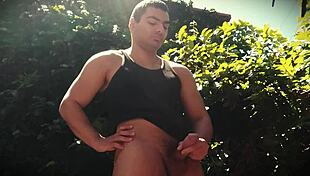 Bodybuilder strokes big dick outdoors enjoying sun and nature