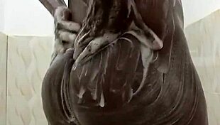 Horny guy strokes huge cock in steamy shower solo