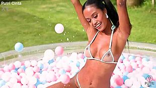 putri cinta splashes playfully in paddling pool footage