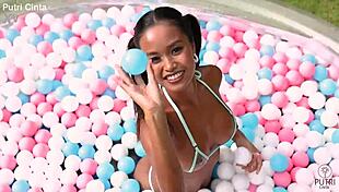 putri cinta splashes playfully in paddling pool footage